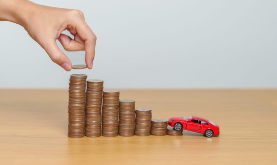 Money Saving, Car Insurance, Financial, vehicle Repair and Maintenance concepts. coins stack and piggy bank with Auto model, Money stack Counting arrangement for deposit and Automobile Tax
