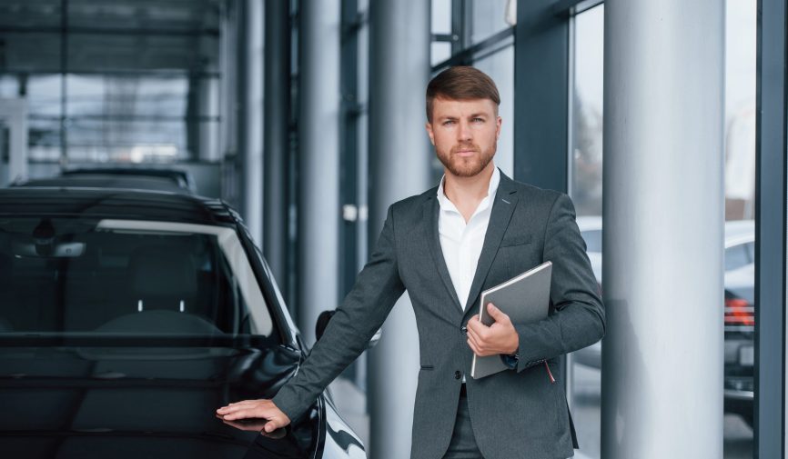 Confident look. Modern stylish bearded businessman in the automobile saloon.