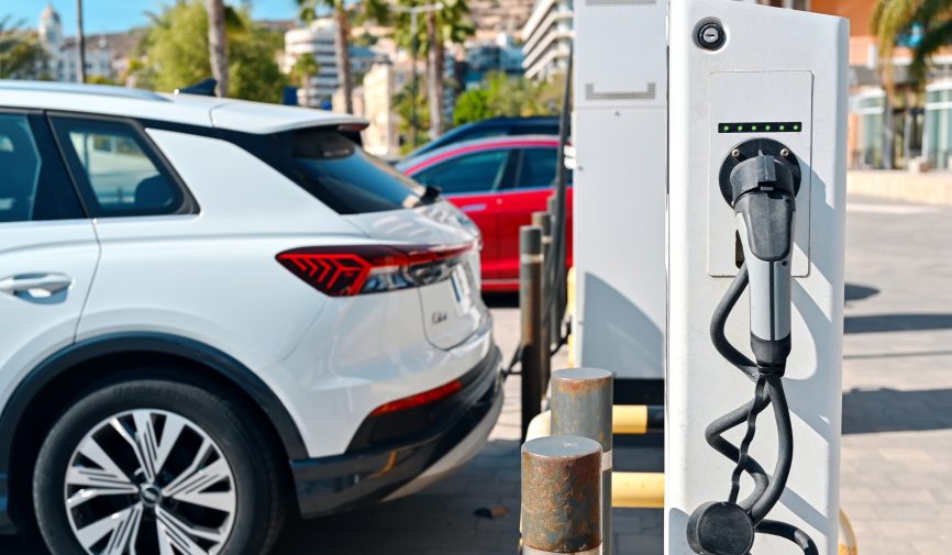 Electric car Audi Q5 charging at the charging station Collage of people buying, selling, and driving cars including luxury vehicles, electric cars, car dealerships, and family car transactions.