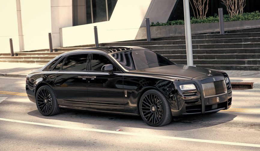 Miami Beach, Florida USA - April 15, 2021: rolls-royce mansory car, side view Collage of people buying, selling, and driving cars including luxury vehicles, electric cars, car dealerships, and family car transactions.